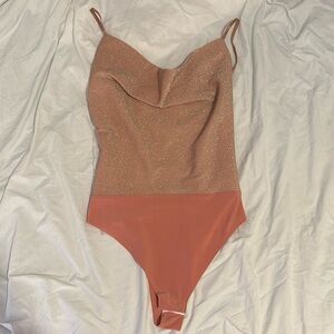 Pink sparkly body suit